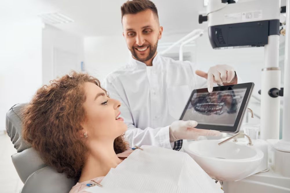 dentist showing a digital smile design preview to a patient during consultation